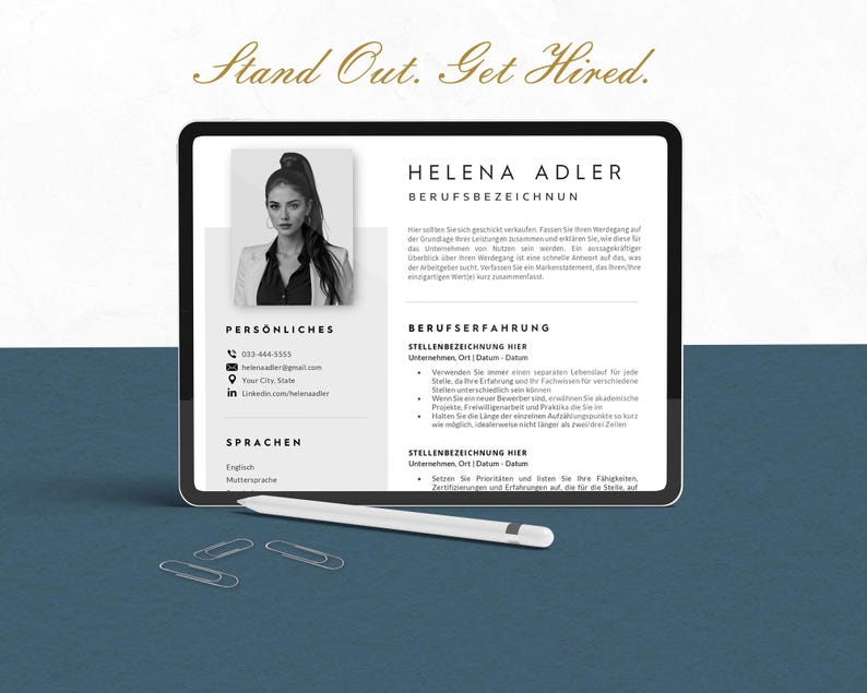 May include: A digital tablet displaying a resume template with the name "Helena Adler" and the text "Stand Out. Get Hired." A stylus and paper clips are on the surface. The resume includes personal and professional experience sections.