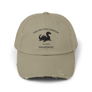 Hide and Seek Champion Undefeated Hat  Funny Distressed Loch Ness Monster Cap
