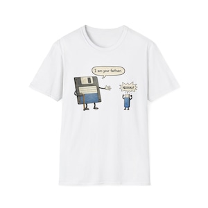 May include: White t-shirt featuring a cartoon illustration of a floppy disk and a USB drive. The floppy disk, with a cane, says "I am your father." The USB drive replies "Noooo!" in a speech bubble. A humorous design.