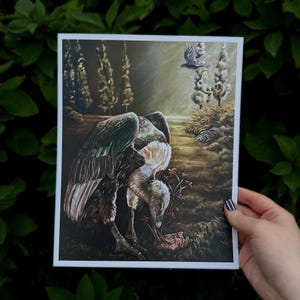 Può includere: Una stampa artistica rettangolare con un dipinto cupo e suggestivo di un grande avvoltoio dalle piume bianche e marroni in una radura. L'uccello si china su una mano umana che emerge dal terreno, circondata da piccoli fiori di colore rosso.