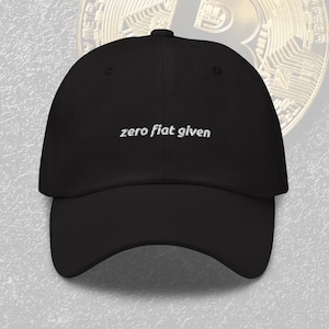 May include: Black baseball cap with the embroidered text "zero fiat given" in white. The cap has a curved brim and a button on top. The background features a Bitcoin coin.
