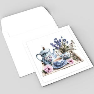 May include: Watercolor illustration of a tea set on a wooden tray, including a teapot, teacup, and small vase with lavender and other flowers. Pink flowers are scattered around the tray. The image is on a white card with a white envelope.