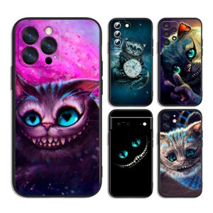 May include: A collection of five smartphone cases featuring various artistic illustrations of a cat with large, bright blue eyes and a wide, toothy grin. The designs incorporate vibrant purple, pink, and dark blue color palettes with whimsical details.