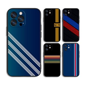 May include: A collection of smartphone cases with various designs. One case has a gradient blue background with white diagonal stripes. Other cases feature black backgrounds with yellow stripes, a PUBG logo, and colorful stripes. Another case is navy blue with red and white stripes.
