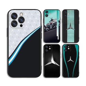 May include: Collection of phone cases with various designs. One case features a white and gray pattern with a blue stripe. Other cases showcase a race car, a silver emblem, and a teal and black design.