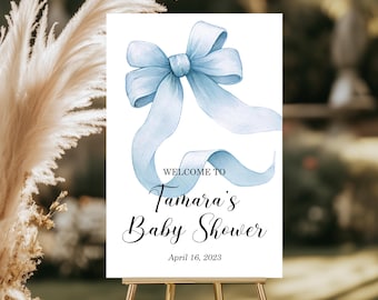 Puede incluir: Un cartel de bienvenida para un baby shower con un lazo azul de acuarela y el texto "Bienvenido a la Baby Shower de Tamara el 16 de abril de 2023".