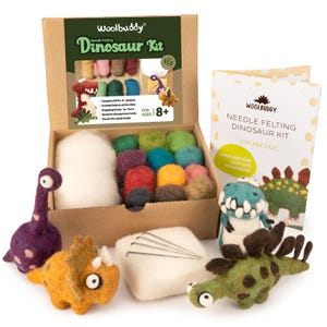 May include: A Woolbuddy Dinosaur Kit for ages 8+. The kit includes a cardboard box with colorful wool balls, needles, and a booklet. Several felted dinosaur figures are displayed, including a purple Brontosaurus and an orange Triceratops.