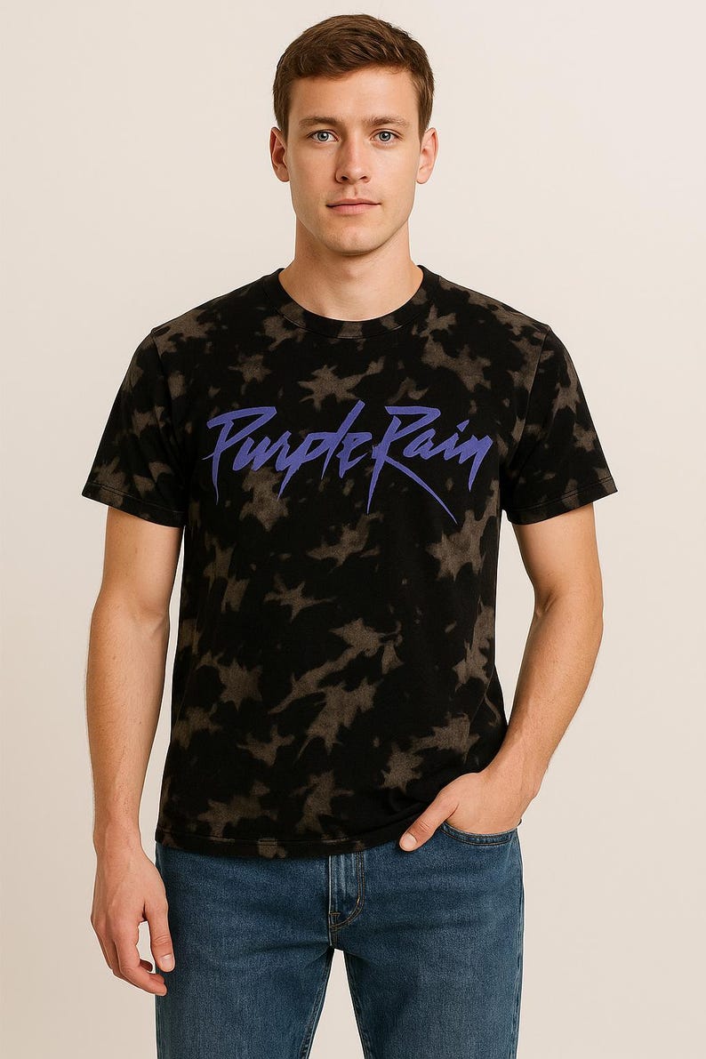 May include: A black t-shirt with a tie-dye pattern and the words "Purple Rain" in purple lettering.