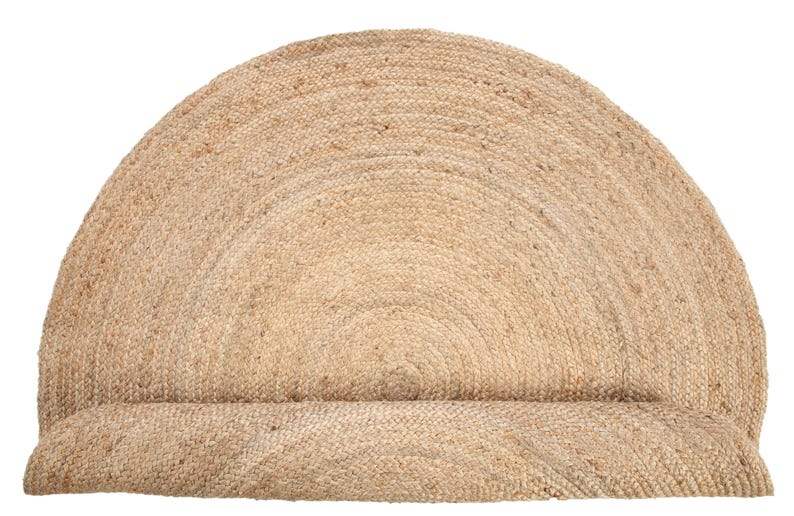 May include: A natural fiber, round, jute rug with a half-circle shape. The rug is made of woven jute and has a natural, earthy color.