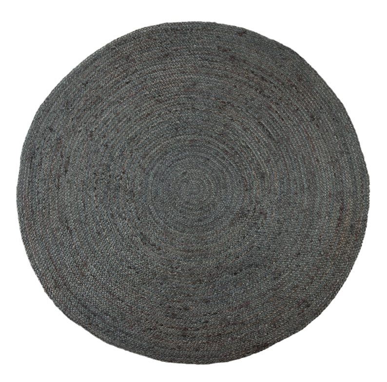 May include: A round, gray jute rug with a woven texture. The rug has a circular design with concentric circles.
