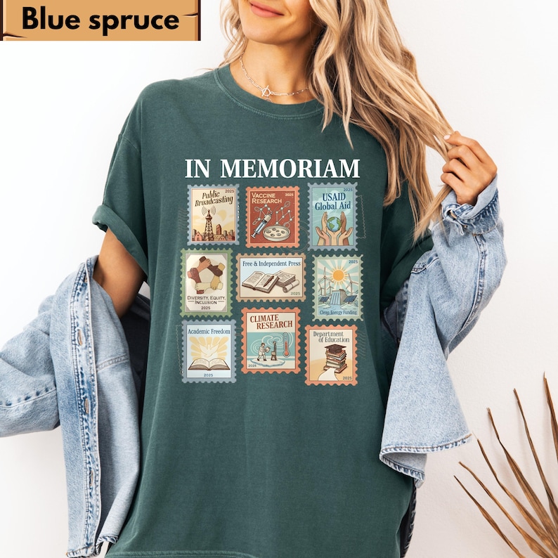 May include: A blue spruce t-shirt with the words "IN MEMORIAM" above a collection of postage stamp designs. The stamps feature text such as "Public Broadcasting," "Vaccine Research," and "Climate Research."