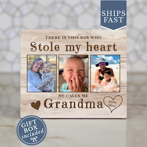 May include: Wooden photo frame with three picture slots. The frame has the text "THERE IS THIS BOY WHO Stole my heart HE CALLS ME Grandma Love, Oliver". The frame includes a gift box.