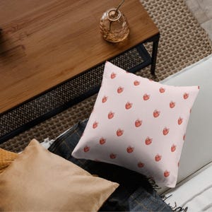 Cushion with strawberry clipart – repeating bow-tied fruit for soft decor