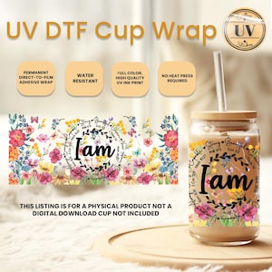 May include: A glass cup with a bamboo lid and straw, featuring a floral design with the word "I am" in the center. The cup wrap is water-resistant and printed with UV ink. The text "UV DTF Cup Wrap" is at the top.