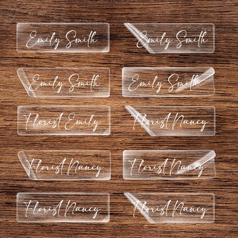 clear acrylic name tags on a wooden surface