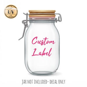 May include: A clear glass jar with a wooden lid and metal clasp. The jar has the words "Custom Label" in pink script. A small circular sticker with "UV Sticker" is in the upper left corner. The text "JAR NOT INCLUDED- DECAL ONLY" is at the bottom.