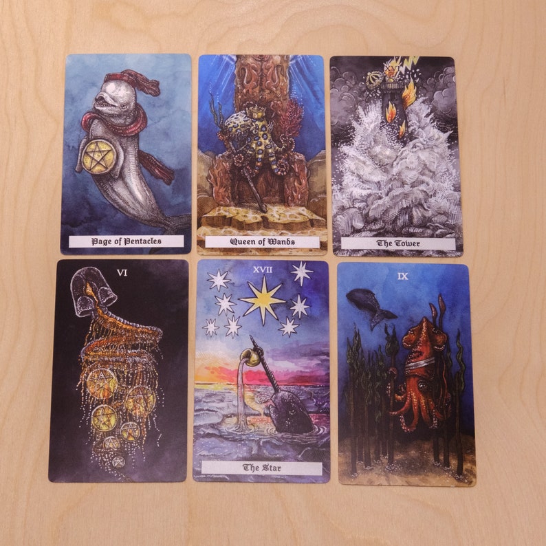May include: A set of ten tarot cards with colorful illustrations. The cards feature images of a sea creature, a star, a tower, a queen, a page, a six, a nine, and a seventeen. The cards are printed on thick cardstock and have a matte finish.