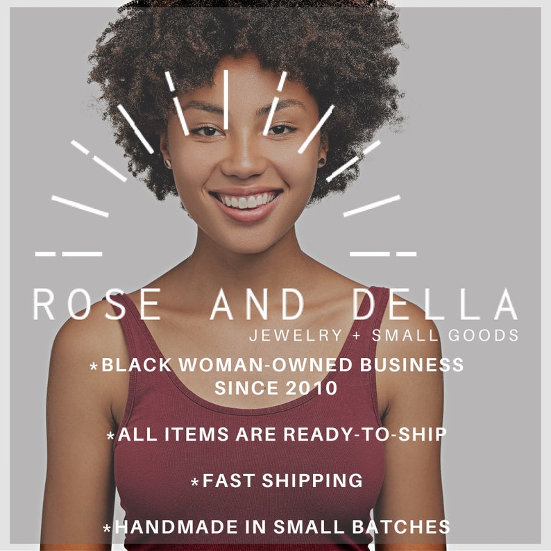 May include: A woman with curly hair smiles at the camera. The text "ROSE AND DELLA" is displayed above her, along with the tagline "JEWELRY + SMALL GOODS". The text "* BLACK WOMAN-OWNED BUSINESS SINCE 2010" is displayed below her. The text "* ALL ITEMS ARE READY-TO-SHIP" is displayed below the tagline. The text "* FAST SHIPPING" is displayed below the text "* ALL ITEMS ARE READY-TO-SHIP". The text "* HANDMADE IN SMALL BATCHES" is displayed below the text "* FAST SHIPPING".