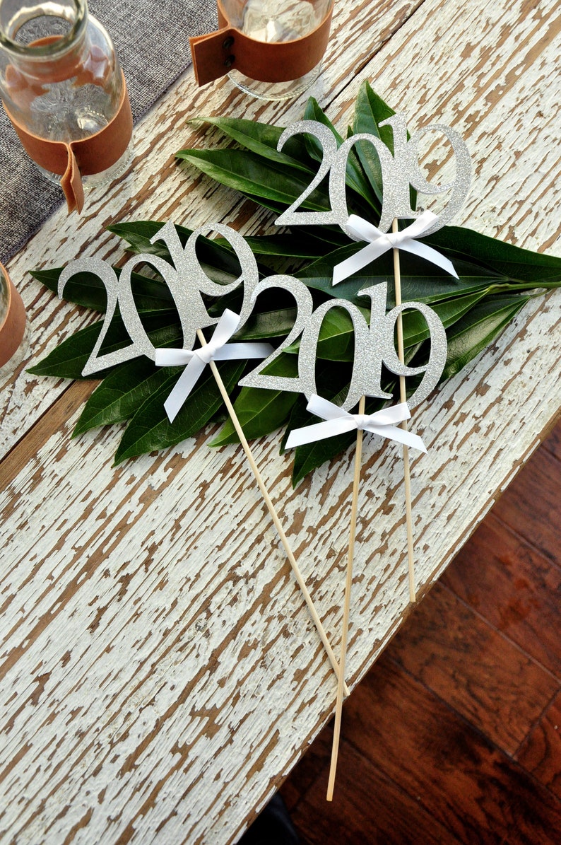2019 Centerpiece. Graduation Centerpiece Silver 2019 Graduation Centerpiece Sticks with White Bows. 3 Single- 2019 Wands