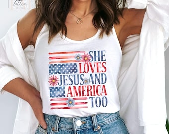May include: White tank top with the text "SHE LOVES JESUS AND AMERICA TOO" in red and blue. The design incorporates American flag elements and floral accents. The top is a sleeveless style.