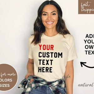 May include: A white t-shirt with black text that says "YOUR CUSTOM TEXT HERE". The text "YOUR" is in red. The shirt is being modeled by a person.