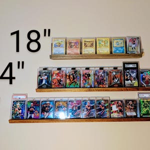 trading card displays in 18", 24" and 36" with sports cards, magic cards, and Pokemon cards mounted to the wall.