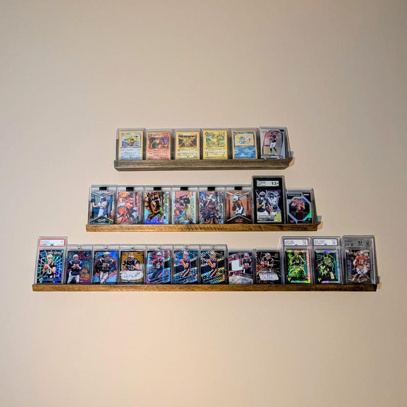 18 inch trading card shelf with Pokemon cards on display mounted to the wall. 24 in sports card shelf with PSA slab cards on display mounted to the wall.  36"  football, baseball, soccer, hockey, and basketball cards displayed on a wall mounted shelf mounted to the wall.  All displays can be used on a desk, nightstand or shelf.