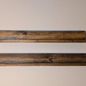 Empty TGC  display shelves in dark mahogany stain.