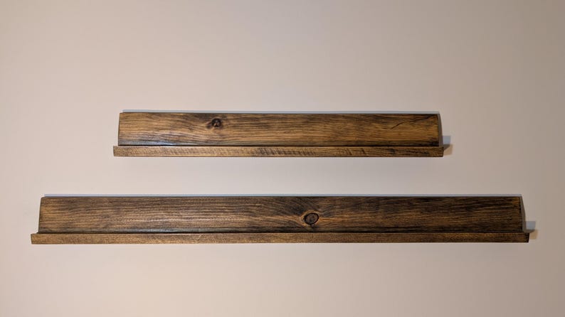 Empty TGC  display shelves in dark mahogany stain.