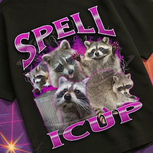 May include: Black t-shirt with a graphic of raccoons and the text "SPELL ICUP". The shirt is part of a retro-themed design with the words "Mildly Perturbed" at the bottom. The image is set against a purple grid background.