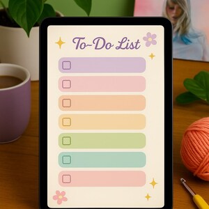 May include: A digital tablet with a to-do list on the screen. The list has six empty boxes with lines next to them. The boxes are in different pastel colors. The screen also has a flower and stars on it. The tablet is on a wooden table.