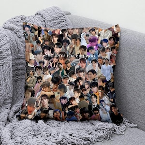 May include: Square cushion featuring a collage of images of a person. The cushion has the text "She loves cha eun-woo" printed on it. The cushion is resting on a grey surface.