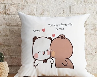 May include: White square pillow with a cartoon illustration of two bears. One bear is white with a black bow tie, and the other is brown. The pillow has the text "Awww" and "You're my favourite person".