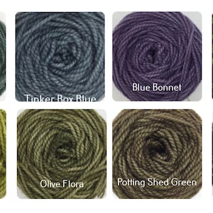 May include: Eight skeins of yarn in various shades of blue and green. The yarn is wound into balls and labeled with names like "Tin Bin Blue", "Tinker Box Blue", "Blue Bonnet", "Rabbit Hill Green", "Horse Apple", "Olive Flora", "Potting Shed Green", and "Cat Hollow".
