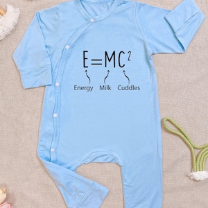 May include: A white ceramic mug with a black handle and the text "But First, Coffee" in a bold, black font. The mug is set against a blurred background, suggesting a cozy setting.