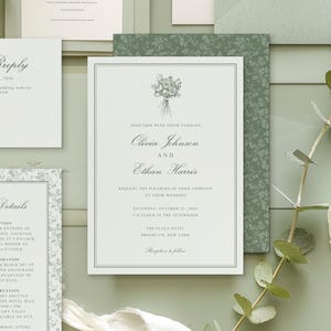 May include: Elegant wedding invitation suite in shades of green and white. The main invitation features the names Olivia Johnson and Ethan Harris, with floral accents. Additional cards include RSVP and details information.