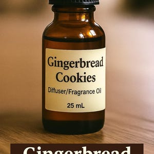May include: A brown glass bottle with a black cap, labeled "Gingerbread Cookies Diffuser/Fragrance Oil, 25 mL." The label is cream-colored with black text. The bottle sits on a wooden surface.
