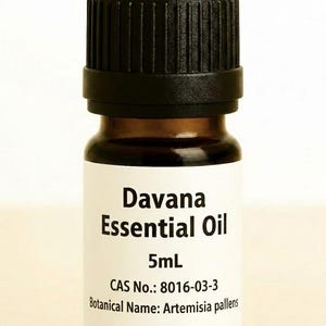 May include: A small, brown glass bottle of Davana Essential Oil with a black cap. The white label displays the product name, volume (5mL), CAS number, and botanical name.
