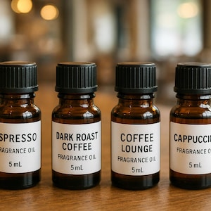 May include: Four small brown glass bottles with black caps, each labeled with a different coffee-related fragrance oil: Espresso, Dark Roast Coffee, Coffee Lounge, and Cappuccino. Each bottle contains 5 mL of oil.