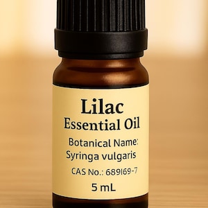May include: A small amber glass bottle of Lilac Essential Oil with a black cap. The label includes the text "Lilac Essential Oil", "Botanical Name: Syringa vulgaris", and "5 mL".