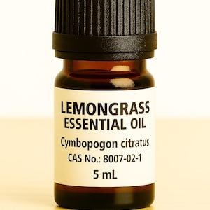 May include: A small amber glass bottle of lemongrass essential oil with a black cap. The label reads "LEMONGRASS ESSENTIAL OIL" and lists the botanical name and volume of 5 mL.