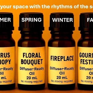 May include: Four brown glass bottles of diffuser oil labeled for different seasons: Summer, Spring, Winter, and Fall. Each bottle has a black cap and a label with the scent name and volume, 20 mL. The text "Sync your space with the rhythms of the seasons" is at the top.