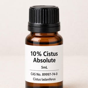 May include: A small amber glass bottle with a black cap, labeled "10% Cistus Absolute" and "5mL". The label also includes the CAS number 89997-74-0 and the name "Cistus ladaniferus".