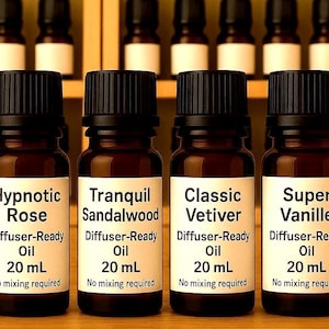May include: Five amber glass essential oil bottles with black caps, labeled "Aqua-Marine", "Hypnotic Rose", "Tranquil Sandalwood", "Classic Vetiver", and "Super Vanille". Each bottle contains 20 mL of diffuser-ready oil.
