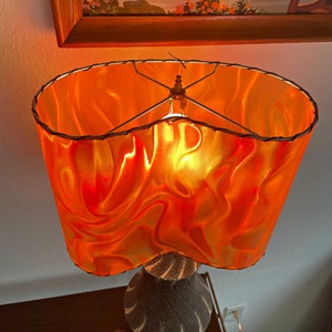 MCM or Tiki-style lampshade.  Amoeba or Kidney-shape in Orange/Red/Yellow tones.  Perfect for any retro or modern decor!