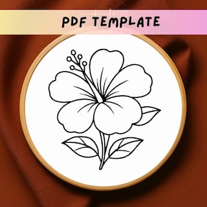 May include: A black and white floral embroidery pattern in a wooden hoop. The design features a hibiscus flower with leaves and stems. The text "PDF TEMPLATE" is displayed at the top. This is a digital download for embroidery enthusiasts.