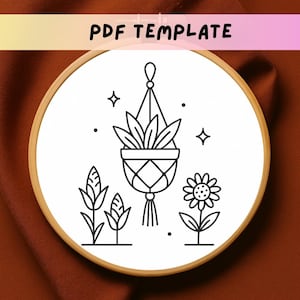 May include: A black and white line drawing of a hanging plant, a flower, and other plants inside a wooden embroidery hoop. The text "PDF TEMPLATE" is at the top. The design is on a white background.