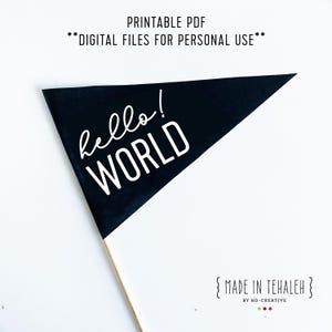 May include: A black pennant flag with the words "hello! WORLD" in white script. The flag is triangular and mounted on a wooden stick. The text "PRINTABLE PDF" and "DIGITAL FILES FOR PERSONAL USE" are at the top.