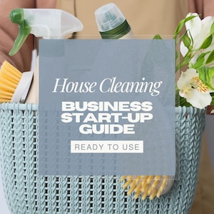 May include: A light blue basket filled with cleaning supplies, including a spray bottle, a brush, and a bottle. A sign in the basket reads "House Cleaning BUSINESS START-UP GUIDE READY TO USE". White flowers are also in the basket.