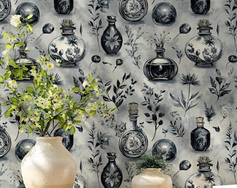 May include: A light-coloured ceramic vase with white flowers and a smaller matching ceramic bowl sit on a wooden table against a wallpaper featuring a repeating pattern of dark blue apothecary bottles, botanical sprigs, and circular shapes.